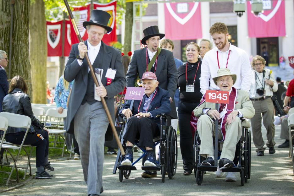 Bertram Huberman ’44 (wheelchair left) and George Post ’45 processing into Tercentenary Theatre on Harvard Alumni Day, 2024.