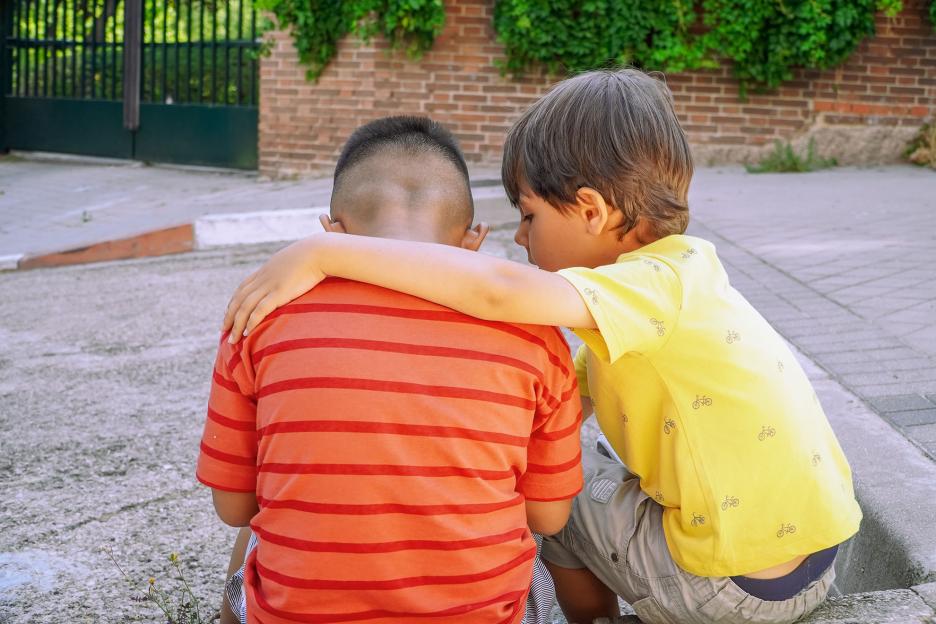LIttle boy comforting his friend.