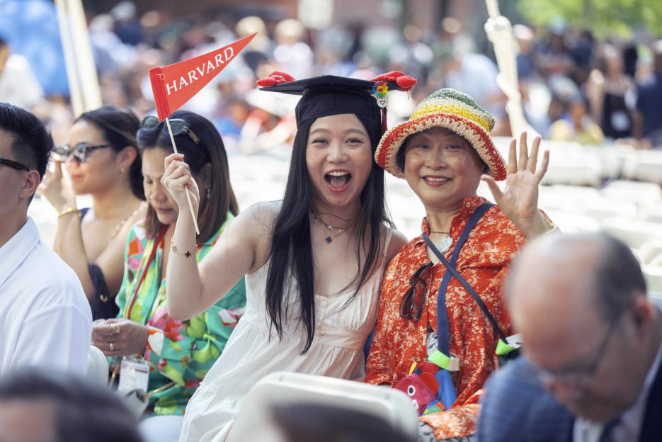 Lucie Zhuxi Wang, HGSE ’23 and her mother cheer during Harvard Alumni Day, 2023.