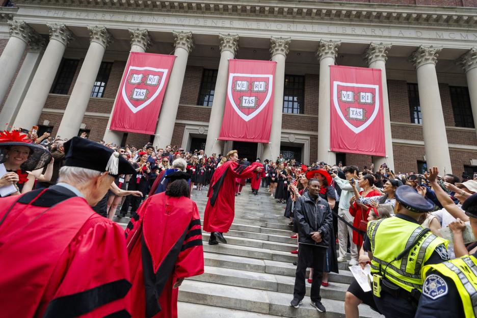Conan O’Brien walks the steps of Widener Library.