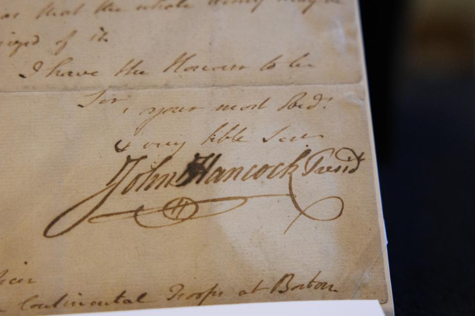 A photo of a document containing John Hancock's signature.