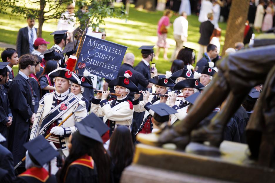 John Nichols, a Harvard employee, leads his group, the Middlesex County Volunteers Fifes & Drums, into Harvard Yard as