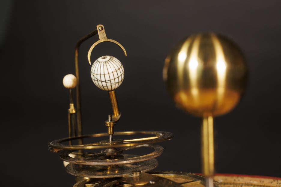 A close-up photo of a portable orrery from 1787