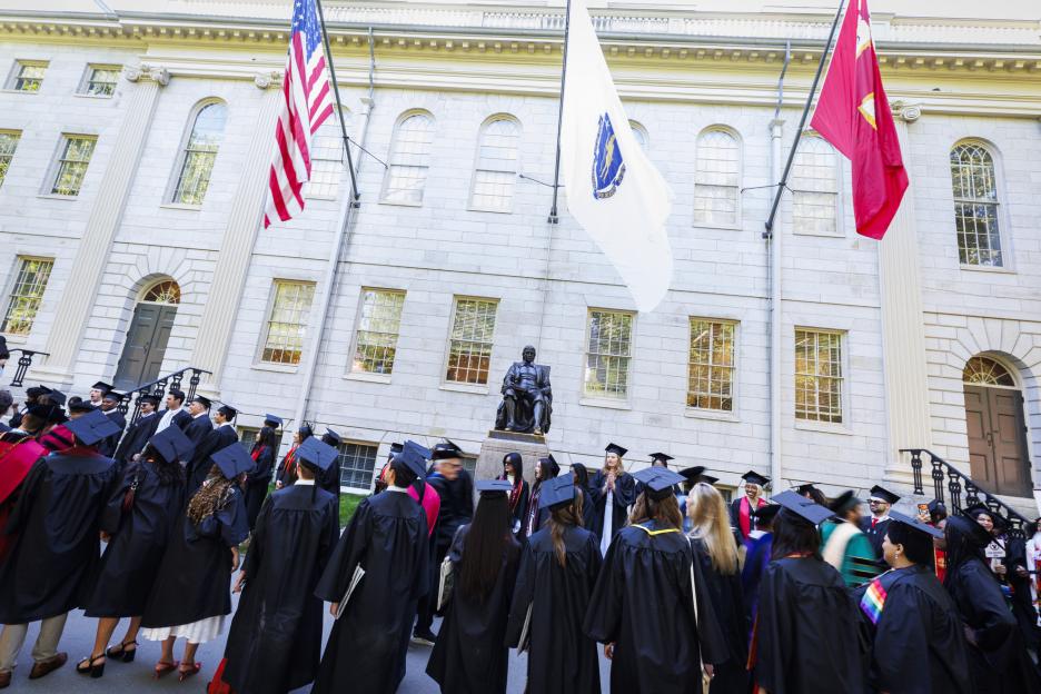 Students line up at the John Harvard Statue for the procession