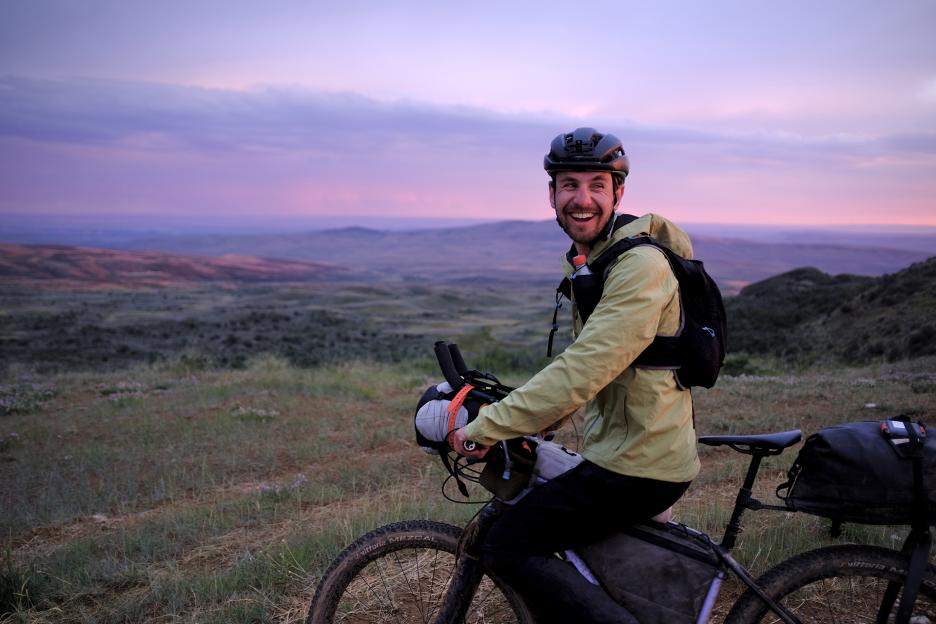 George Usmanov rides at sunset through southern Wyoming for the Tour Divide.