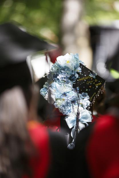 A graduate wears a customized mortarboard.